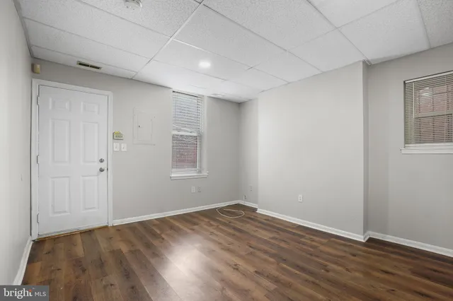 a view of an empty room with wooden floor