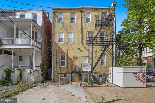 a view of a house with wooden fence