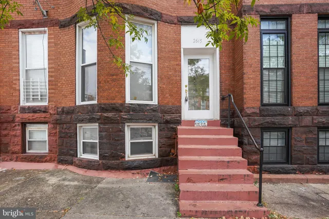 a front view of a house with a yard and windows