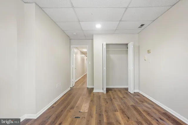 a view of hallway with wooden floor