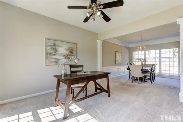a view of a workspace with furniture and a window