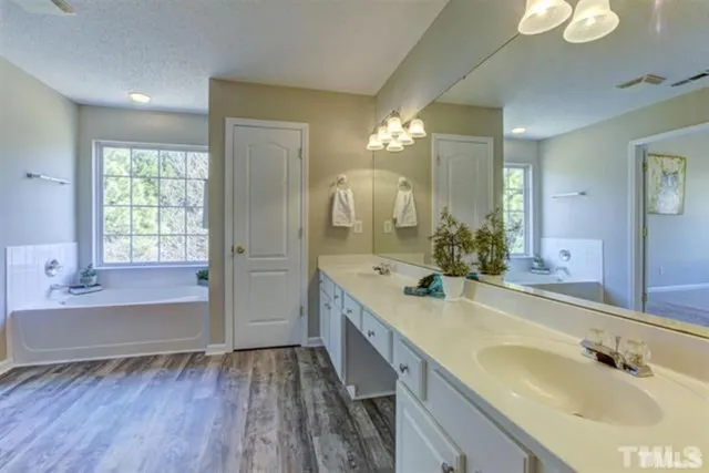 a bathroom with a double vanity sink and a mirror