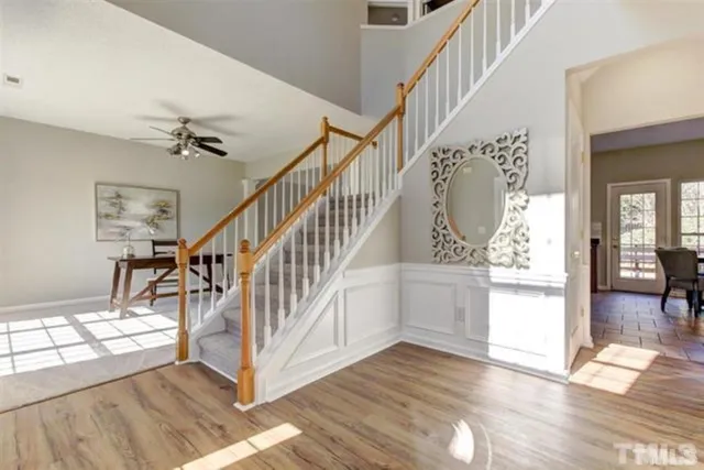 a view of entryway and hall with wooden floor