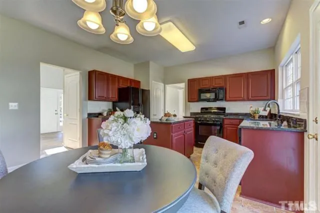 a living room with stainless steel appliances kitchen island granite countertop furniture and a kitchen view