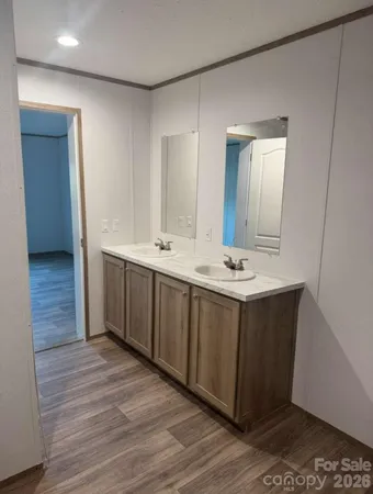 a bathroom with a double vanity sink and a mirror