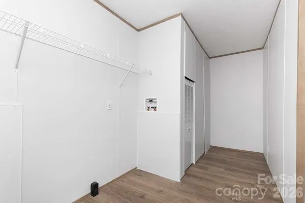 a view of hallway with wooden floor