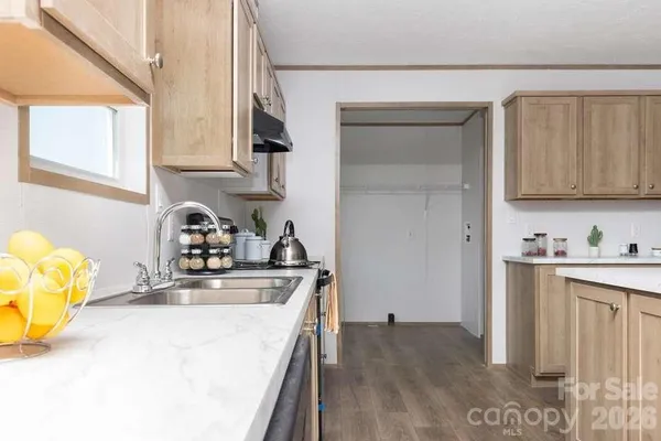 a kitchen with a sink a stove and cabinets
