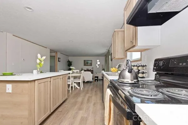 a kitchen with a stove and cabinets