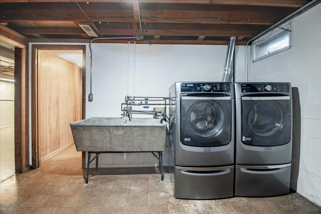 a kitchen with a sink and a washer dryer