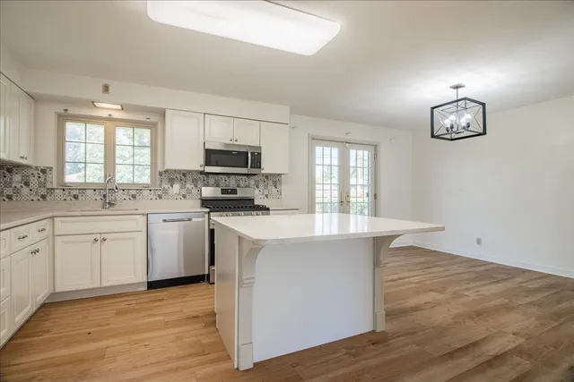 a kitchen with a sink cabinets and window