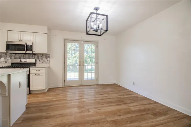 a view of a kitchen with microwave and cabinets