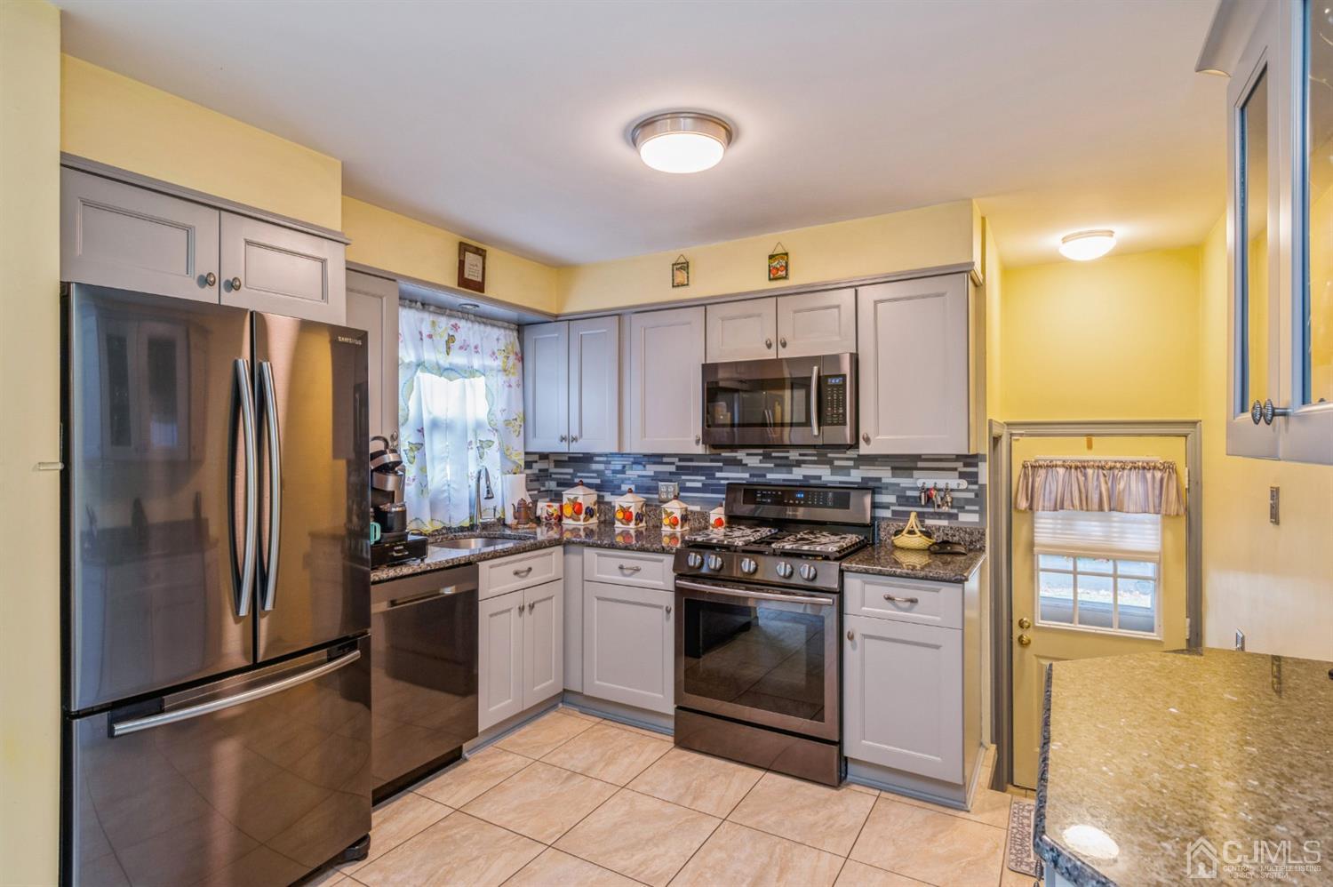 17 Longview Road Old Bridge, NJ 08857 - Photo 2 of 18 a kitchen with stainless steel appliances granite countertop a stove top oven a refrigerator and a sink