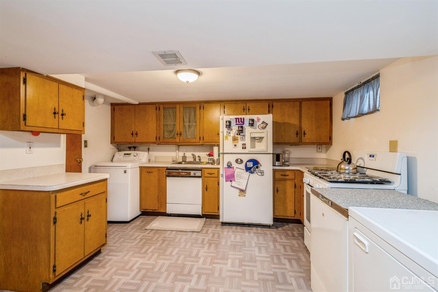 17 Longview Road Old Bridge, NJ 08857 - Photo 16 of 18 a kitchen with a stove top oven sink and cabinets