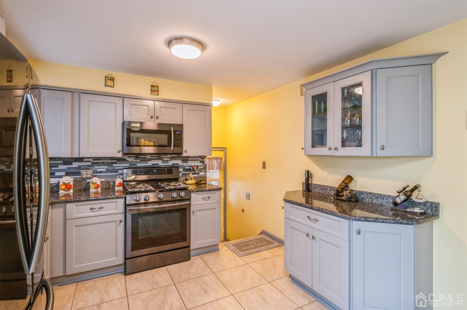 17 Longview Road Old Bridge, NJ 08857 - Photo 3 of 18 a kitchen with stainless steel appliances granite countertop a stove a sink and a microwave