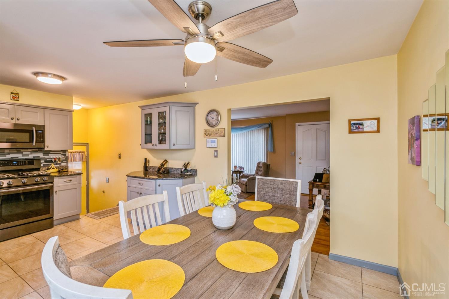 17 Longview Road Old Bridge, NJ 08857 - Photo 5 of 18 a kitchen with stainless steel appliances granite countertop a dining table and chairs