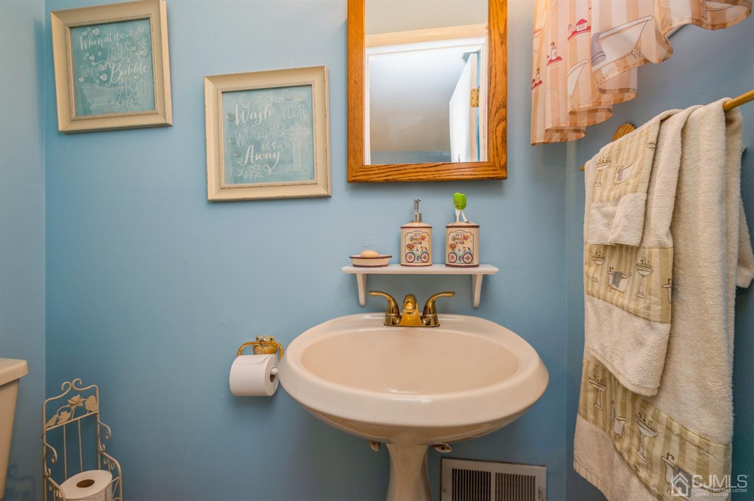 17 Longview Road Old Bridge, NJ 08857 - Photo 10 of 18 a bathroom with a sink a mirror and a toilet