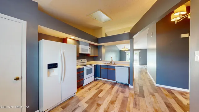 a kitchen with stainless steel appliances a refrigerator and a stove