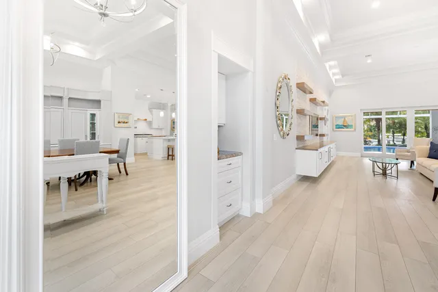 a spacious bedroom with a bed a table and painting