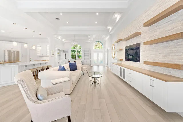 a living room with furniture and a chandelier