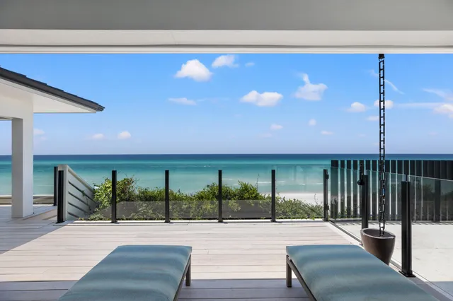 a living room with furniture kitchen view and a large window