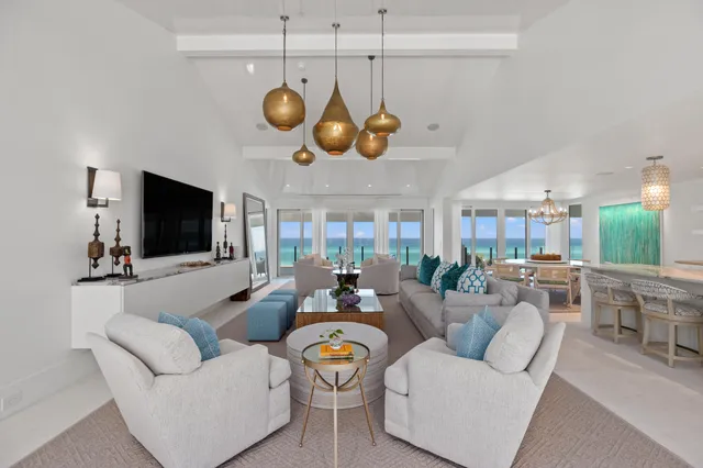 a living room with fireplace furniture and a chandelier