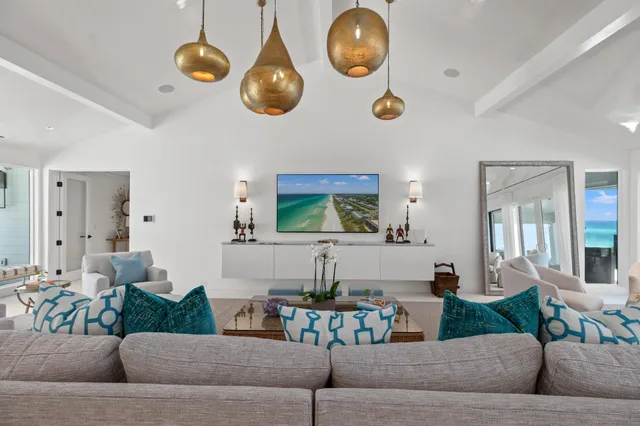 a dining room with furniture a chandelier and window