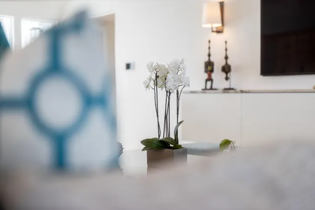 a view of a dining room and livingroom with furniture wooden floor and a chandelier