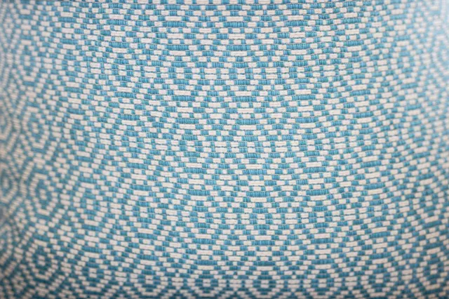 a bedroom with a bed and a lamp on dresser