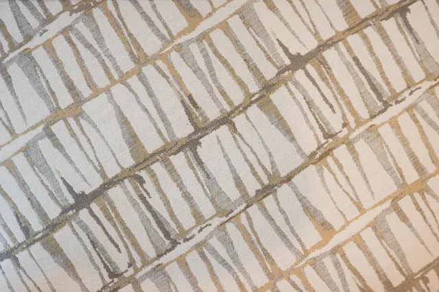 a large bed sitting in a bedroom next to a lamp