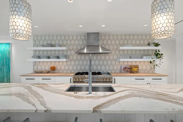 a large bed sitting in a bedroom next to a window