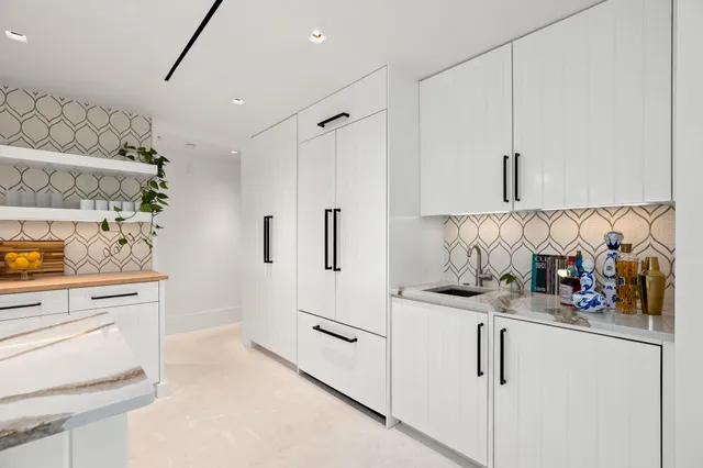 a view of a patio with dining table and chairs