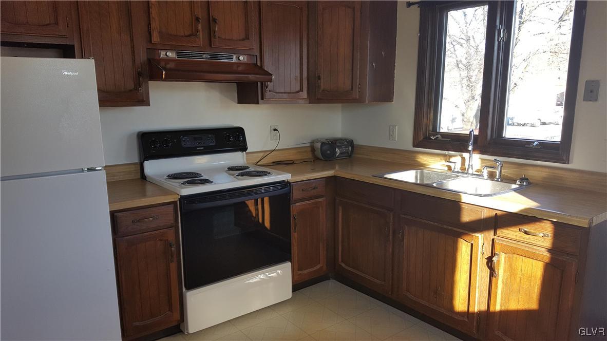 719 Front Street, Unit 2 Hellertown, PA 18055 - Photo 3 of 8 a kitchen with stainless steel appliances granite countertop a stove a sink and a microwave