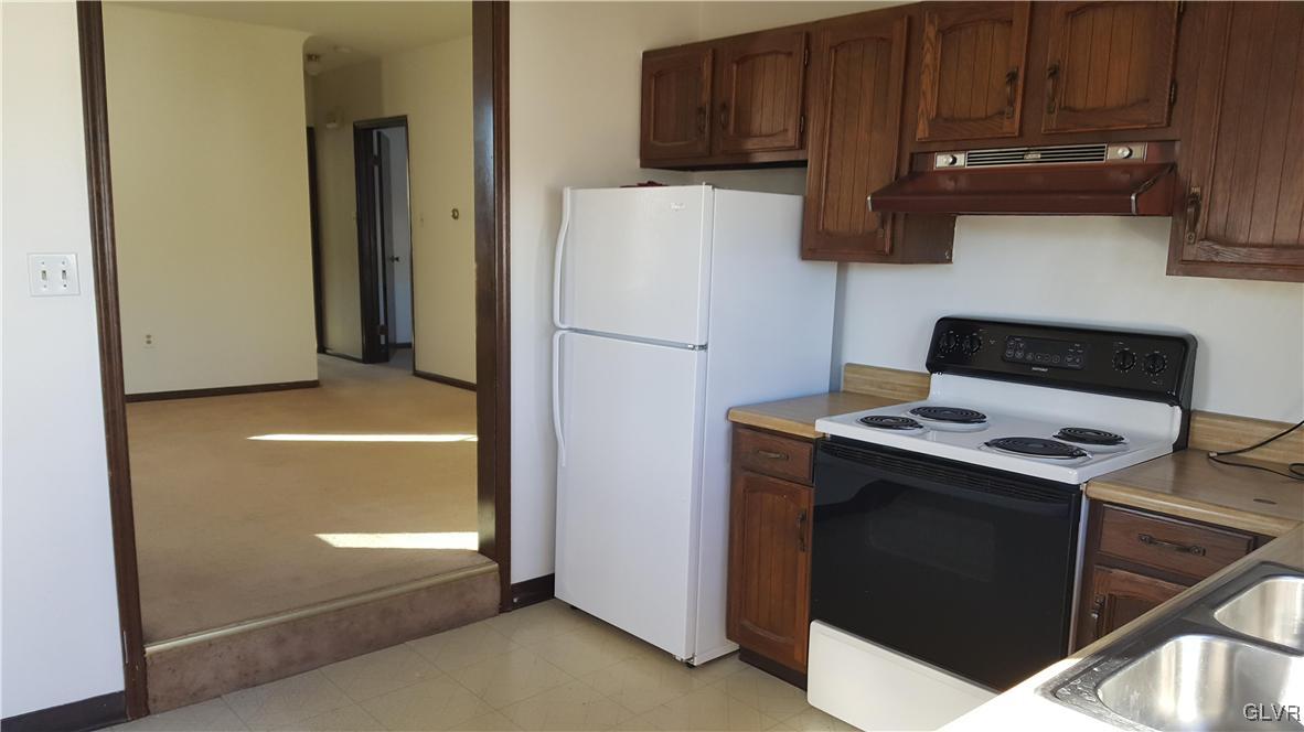 719 Front Street, Unit 2 Hellertown, PA 18055 - Photo 4 of 8 a kitchen with a refrigerator and a stove