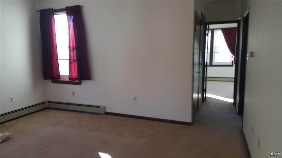 719 Front Street, Unit 2 Hellertown, PA 18055 - Photo 5 of 8 an empty room with windows and closet