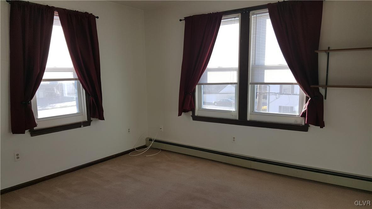 719 Front Street, Unit 2 Hellertown, PA 18055 - Photo 6 of 8 an empty room with windows