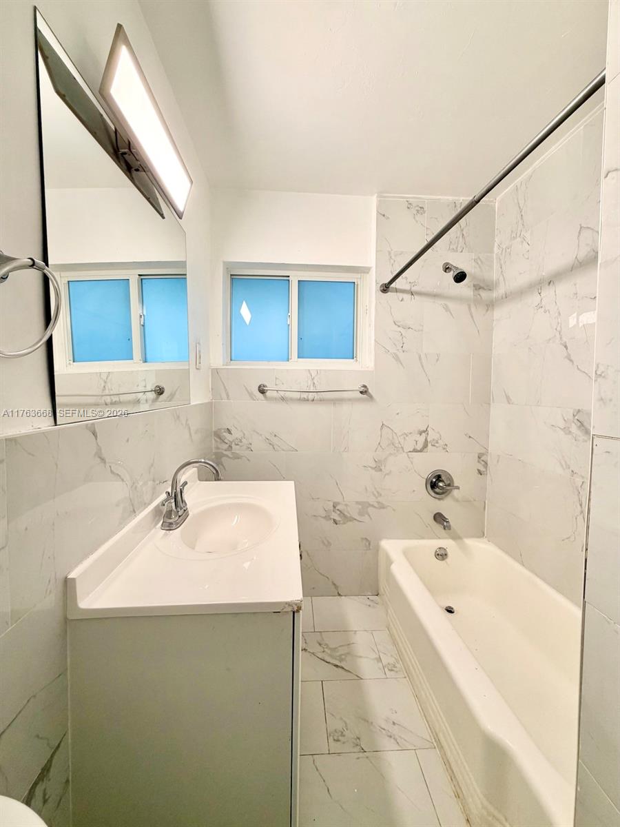 929 Southwest 12th Avenue Miami, FL 33130 - Photo 14 of 38 a bathroom with a tub sink and mirror