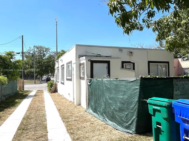 a front view of a house with a garden and yard