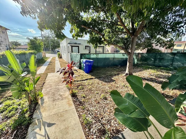 a view of a porch with furniture and garden