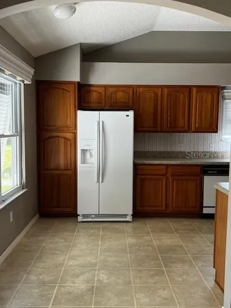 a kitchen with a refrigerator and cabinets