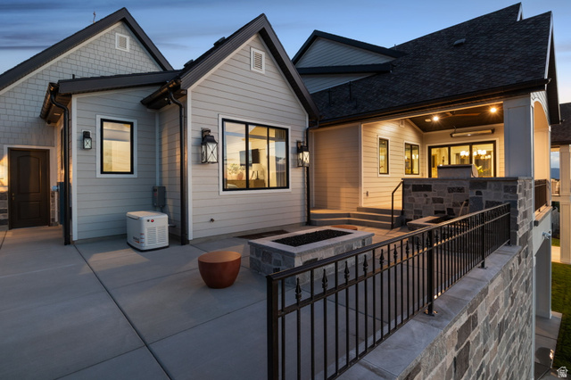 115 East Hidden Ridge Lane, Unit 42 Mapleton, UT 84664 - Photo 86 of 103 Expansive concrete patio featuring a built-in fire pit with stone surround