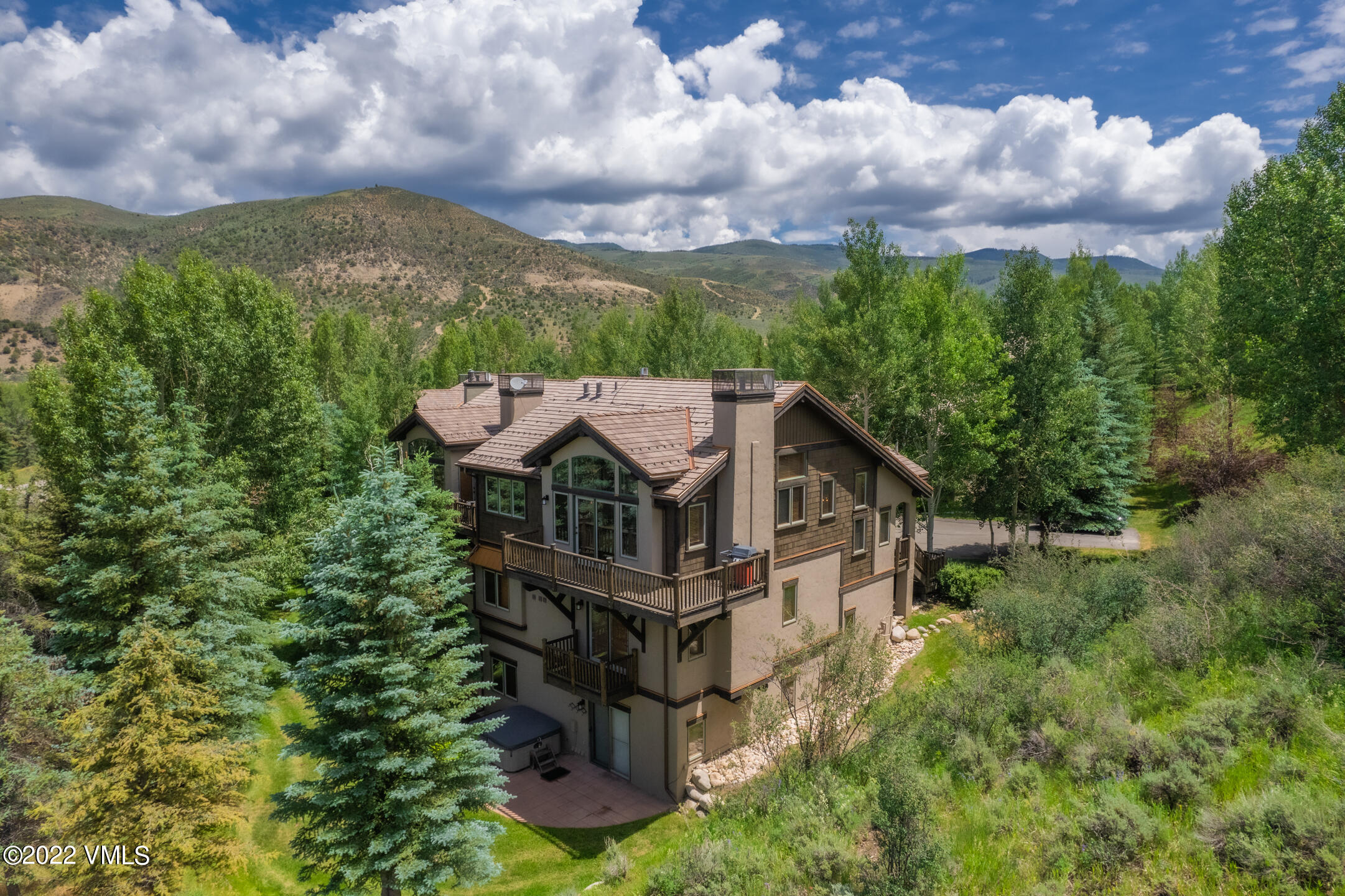53 Knudson Ranch Road Edwards, CO 81632 - Photo 1 of 19 an aerial view of a house with a big yard and large trees