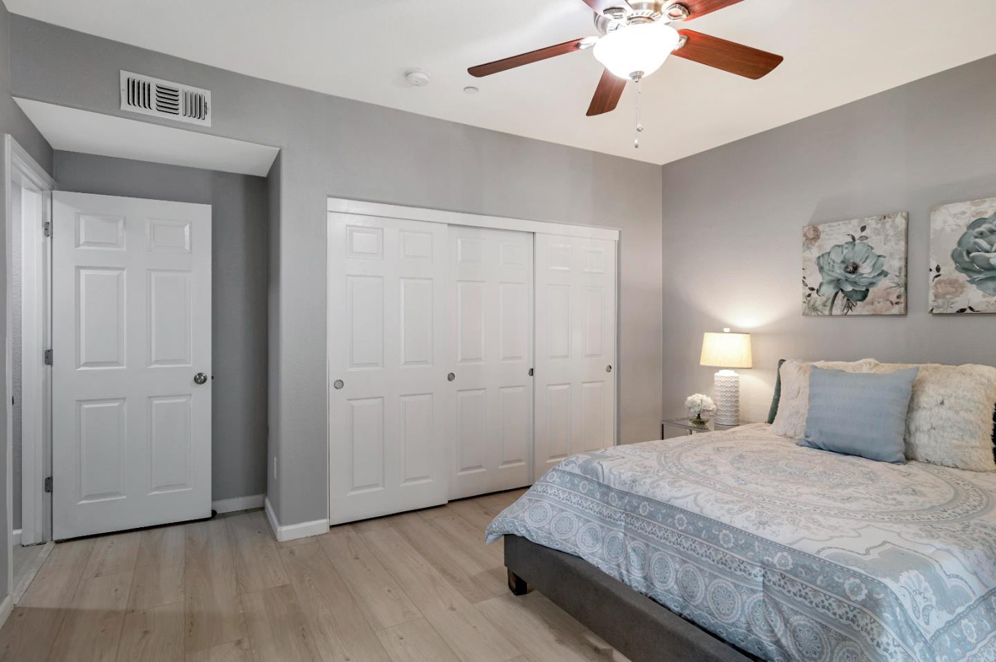 1814 Snell Place Milpitas, CA 95035 - Photo 31 of 49 a bedroom with a large bed and a chandelier
