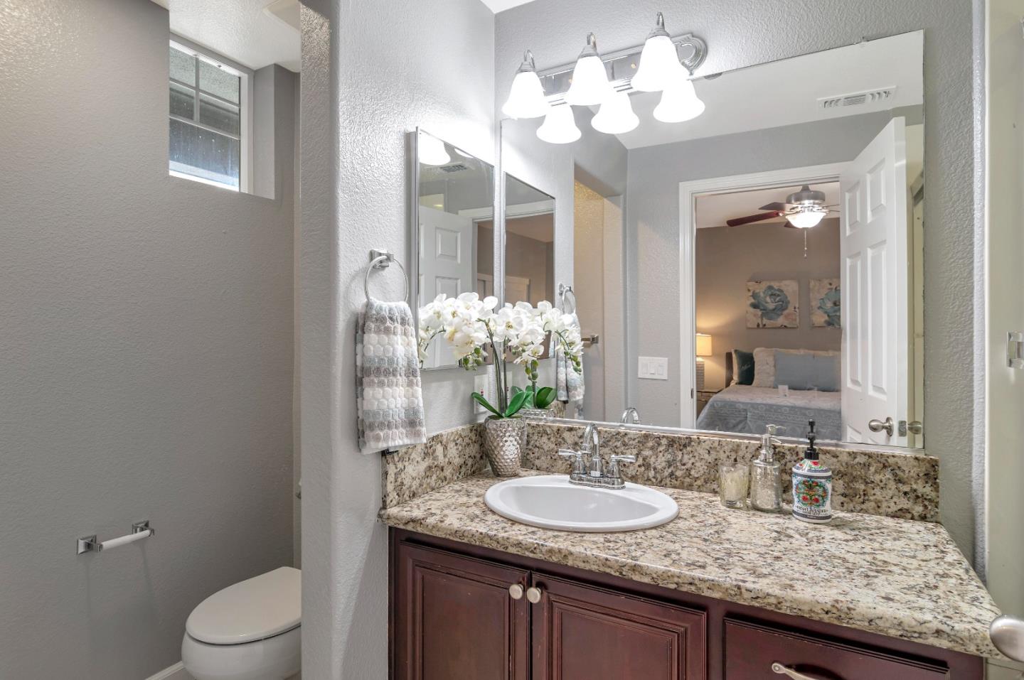 1814 Snell Place Milpitas, CA 95035 - Photo 35 of 49 a bathroom with a granite countertop sink a toilet and a mirror