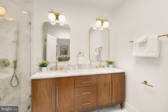 a bathroom with a double vanity sink and a mirror