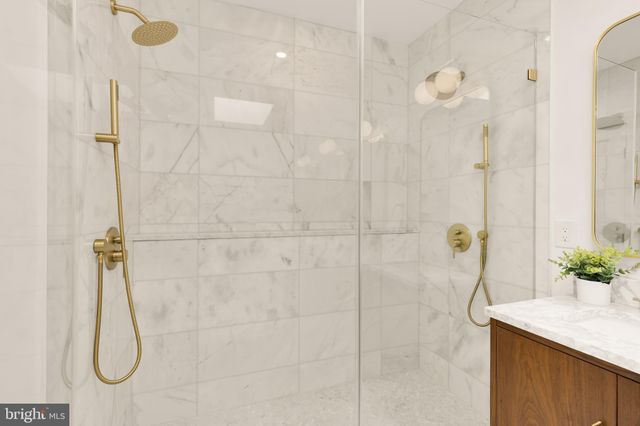 a bathroom with a sink a shower and a mirror