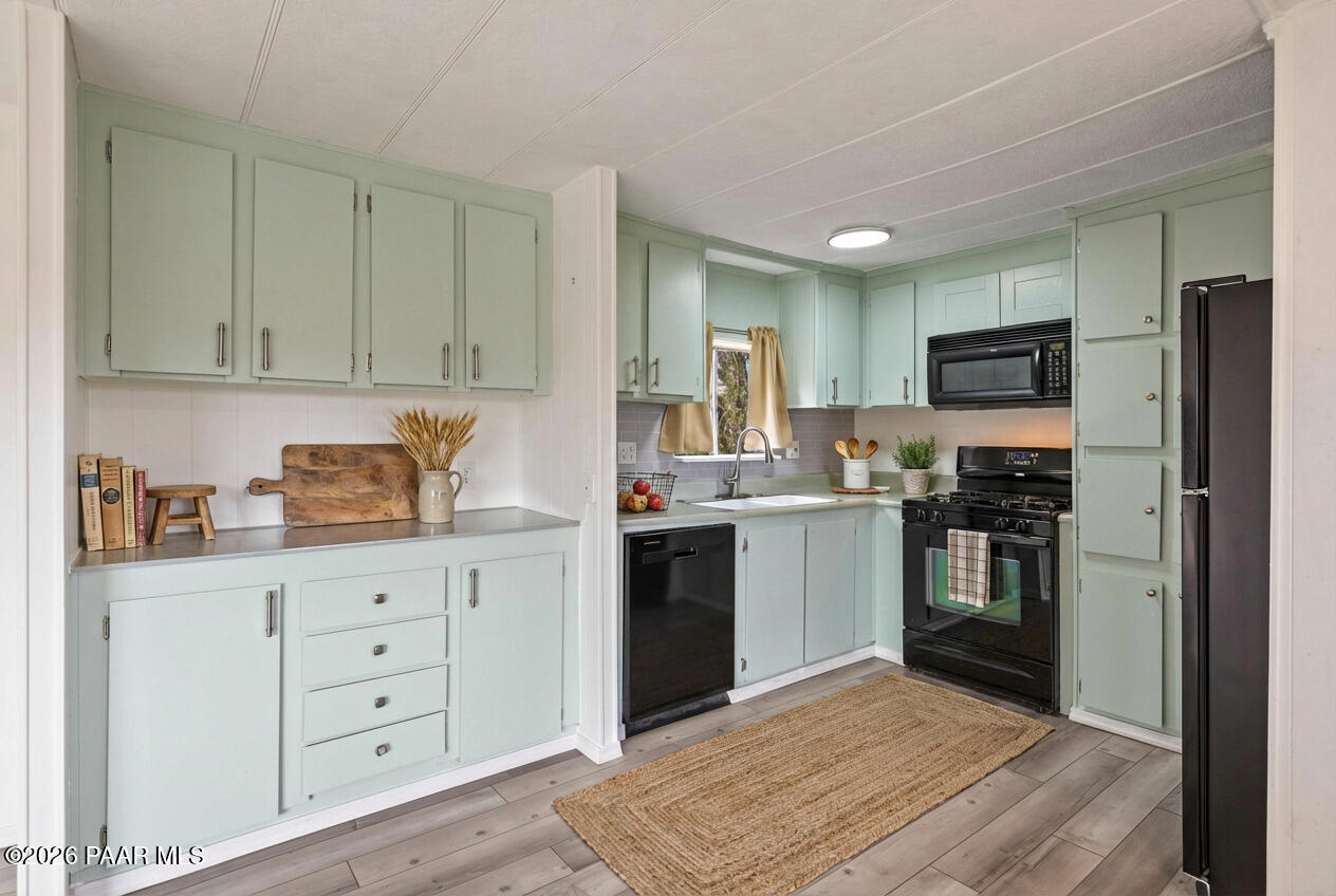 15455 South Rolling Ridge Drive Mayer, AZ 86333 - Photo 7 of 17 a kitchen with granite countertop cabinets and steel stainless steel appliances