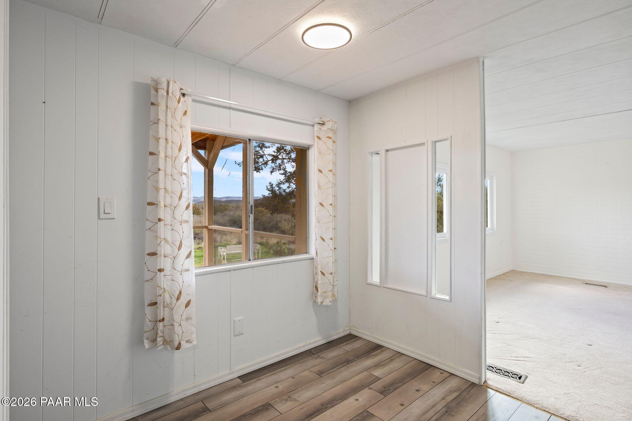 15455 South Rolling Ridge Drive Mayer, AZ 86333 - Photo 9 of 17 a view of an empty room with wooden floor and a window