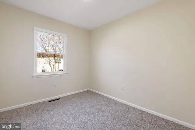 a view of a house with backyard and a tree