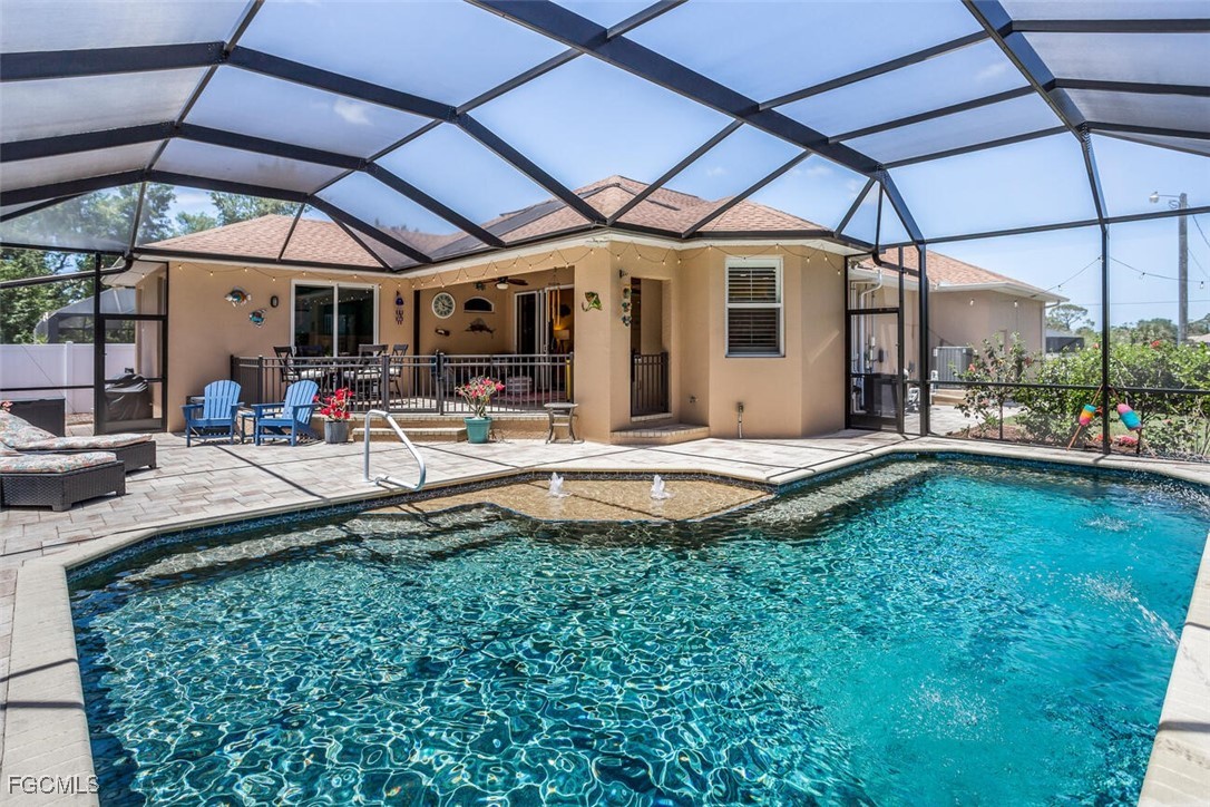 a patio with a table and chairs under an umbrella