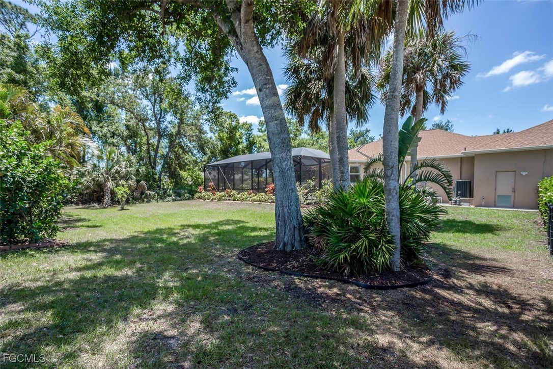 139 Crevalle Road Rotonda West, FL 33947 - Photo 23 of 24 a view of a yard with plants and trees